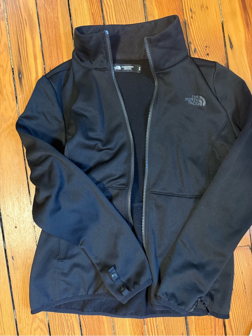 The North Face black softshell/fleece-lined jacket, women’s size Medium